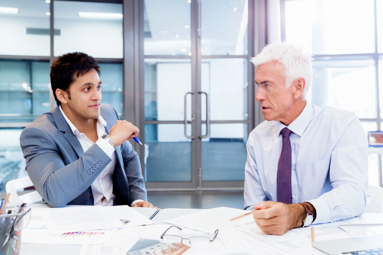 Boss mentoring younger employee