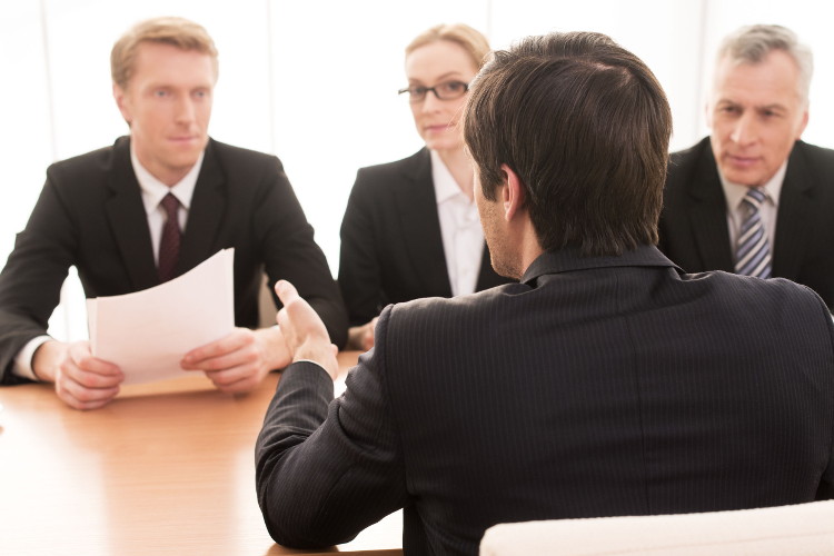 Interviewers listen as candidate answers