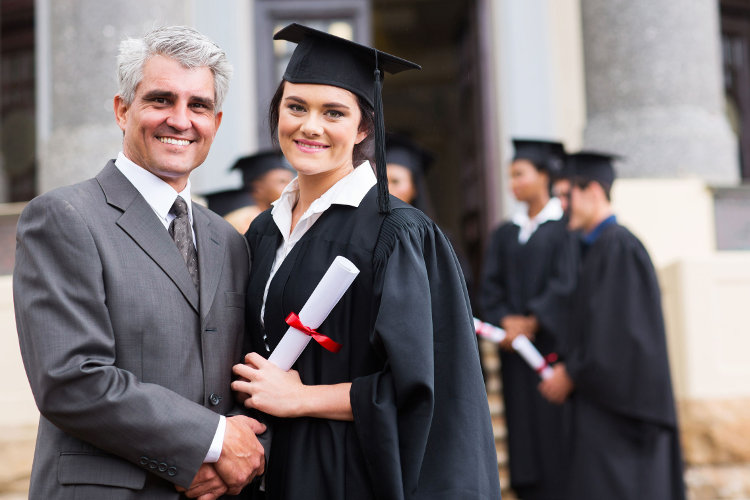 College graduate standing with her father